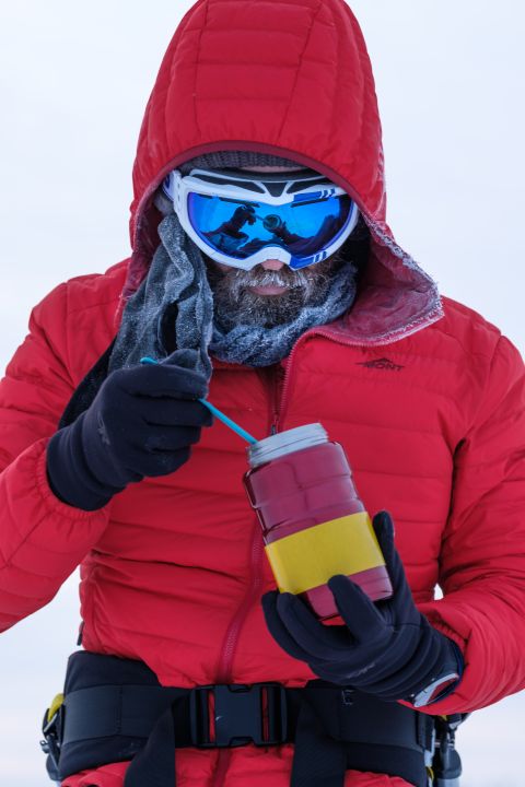 Paul Watkins bundled in a red down jacket and goggles in sub-zero conditions